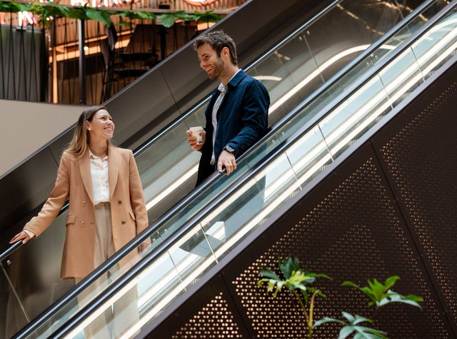 Two people on escalator