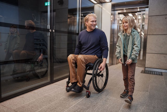 Man in wheelchair and chilld