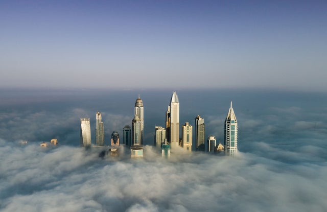 skyscrapers above clouds