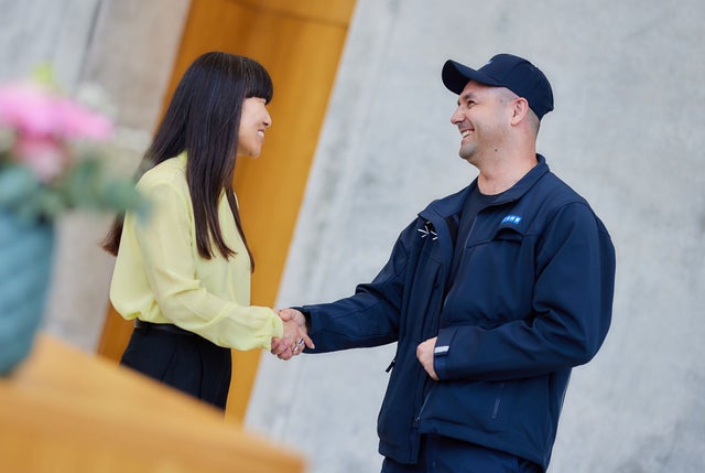 KONE technicial shaking hands with a customer