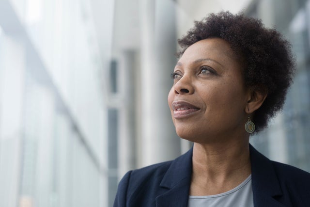 Woman looking into distance through window