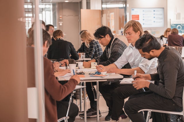 Employees sitting at a table workshopping