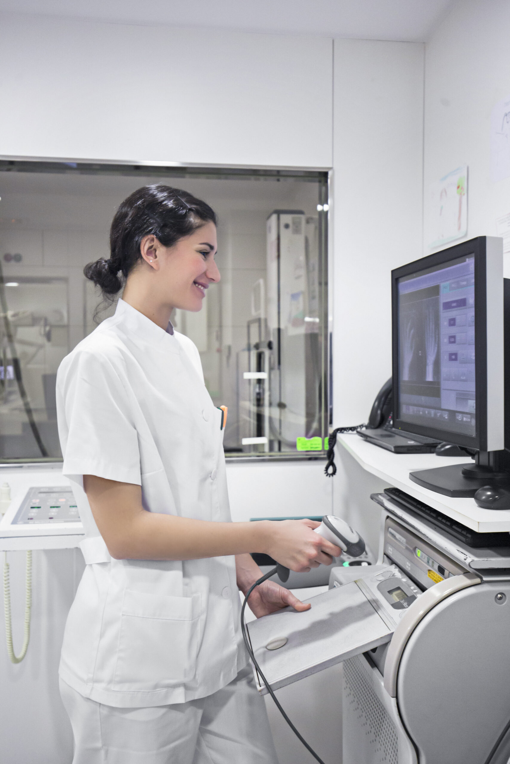 Nurse checking the hand x-ray at the computer screen